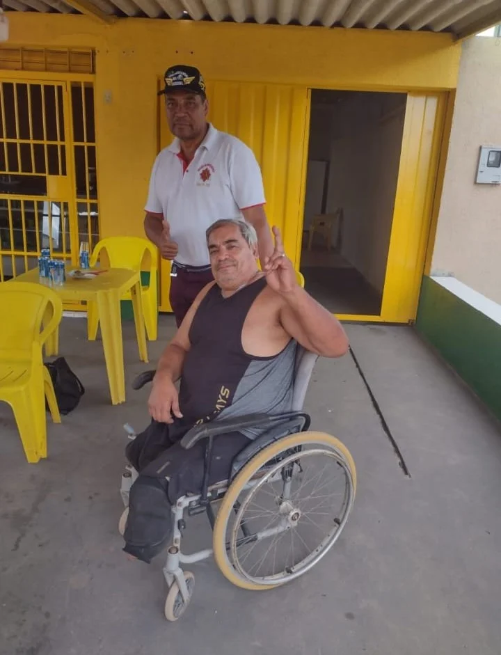 Atleta em cadeira de rodas fazendo sinal de vitória